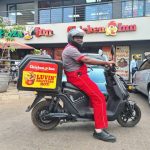 A delivery person on a scooter