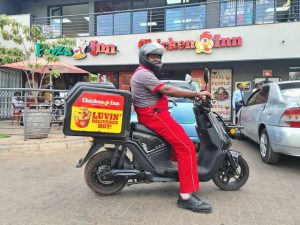 A delivery person on a scooter