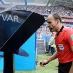 Referee checks with VAR following a goal