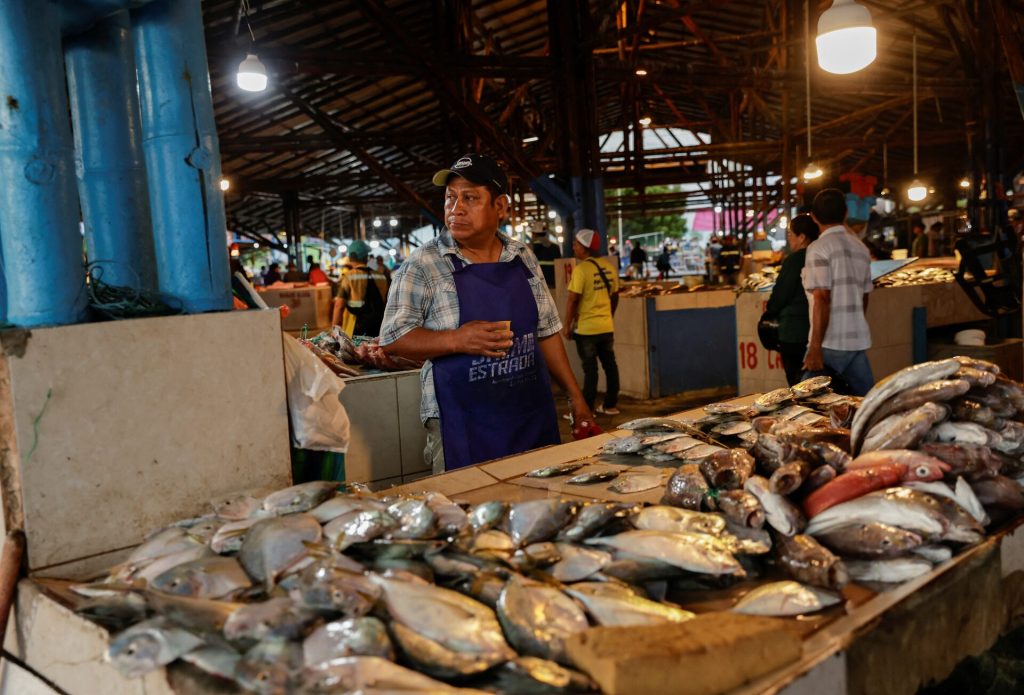 A vendor sells fresh fish at a market as local fishermen are increasingly being pursued by Ecuadorean gangs to move drugs and for their skills navigating the Pacific waters along Ecuador's coast, which has become a hub for the international smuggling of narcotics over the last half-decade, in Manta, Ecuador, June 4, 2026. REUTERS/Karen Toro