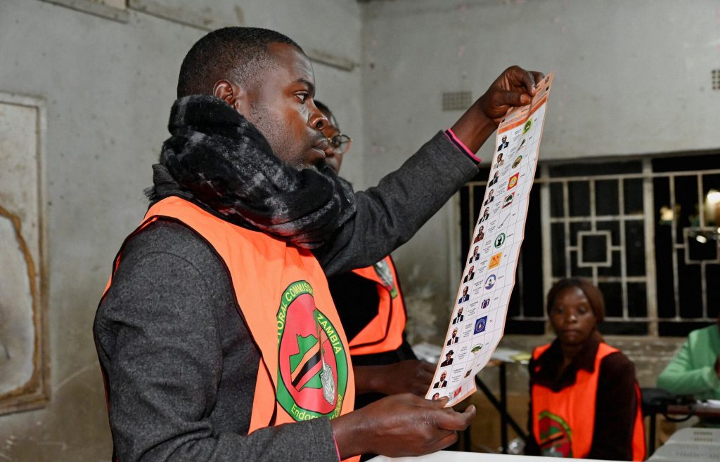 Election officials display a ballot paper while sorting and counting votes after polls close at a polling station during Zambia's general elections, including the presidential election, in Lusaka, Zambia. REUTERS/Moses Mwape