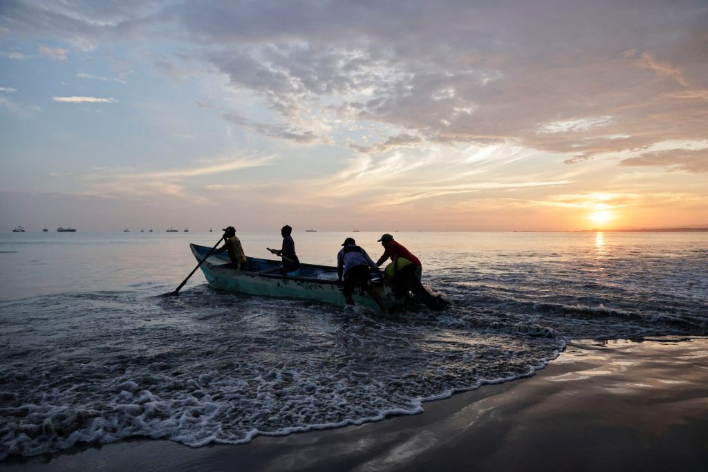 Fishermen work along the shore as local fishermen are increasingly being pursued by Ecuadorean gangs to move drugs and for their skills navigating the Pacific waters along Ecuador's coast, which has become a hub for the international smuggling of narcotics over the last half-decade, in Manta, Ecuador, June 4, 2026. REUTERS/Karen Toro