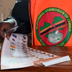 An election official holds a ballot at a polling station during Zambia's general elections, including a presidential election, in Lusaka, Zambia. REUTERS/Moses Mwape