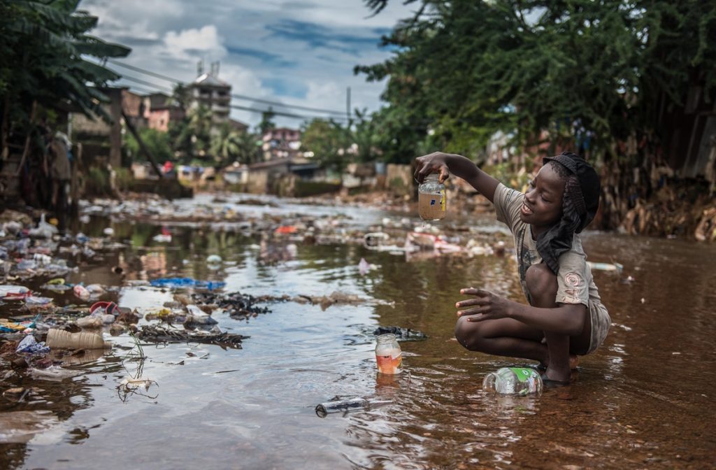 A child playing in dirty water