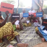 Men hold anti fgm signs