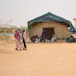 Ouré-Cassoni, Chad - July 23, 2026. Women and children wait in the covered waiting area of the Sexual and Reproductive Health Unit, MSF Outpatient Department, Zone D of the refugee camp. Picture: Flurina Rothenberger for Médecins Sans Frontières