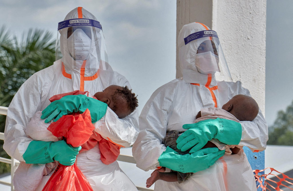 Congolese medical workers dressed in personal protective equipment (PPE) carry children tested and cleared off from Ebola from Saint Nicholas orphanage, at the Centre Medical Evangelique (CME) within the secured Ebola response zone, as aid agencies intensify efforts to contain the Ebola outbreak involving the Bundibugyo strain, in Hoho commune of Bunia town, Ituri province, Democratic Republic of Congo, June 9, 2026. REUTERS/Gradel Muyisa Mumbere TPX IMAGES OF THE DAY