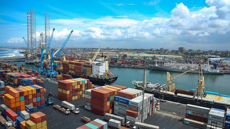 A port with shipping containers being loaded