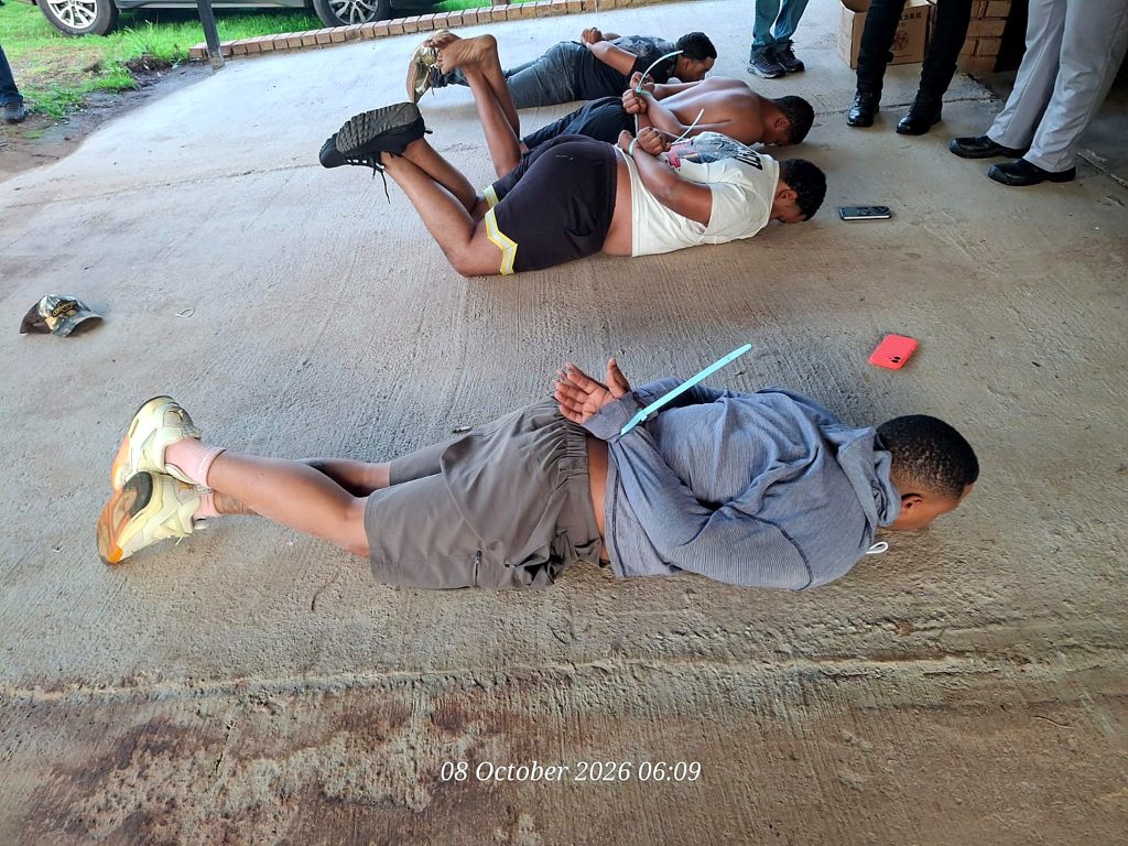 Suspects lie on the ground during the police raid on the Krugersdorp farm. Five South Africans were arrested.