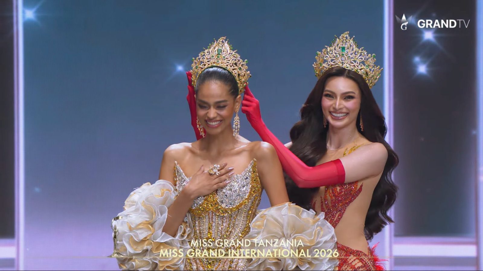 Jihan Dimack of Tanzania reacts as outgoing titleholder Emma Tiglao of the Philippines places the crown on her head, making her Miss Grand International 2026, at the MGI Hall in Bangkok, Thailand, on Saturday night.