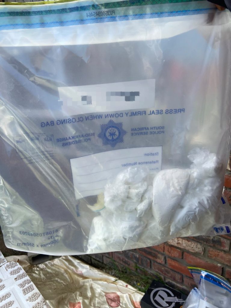 A police evidence bag holding a white powder suspected to be cocaine, seized during the Operation Ukubuza raid in Rowallan Park, Gqeberha.