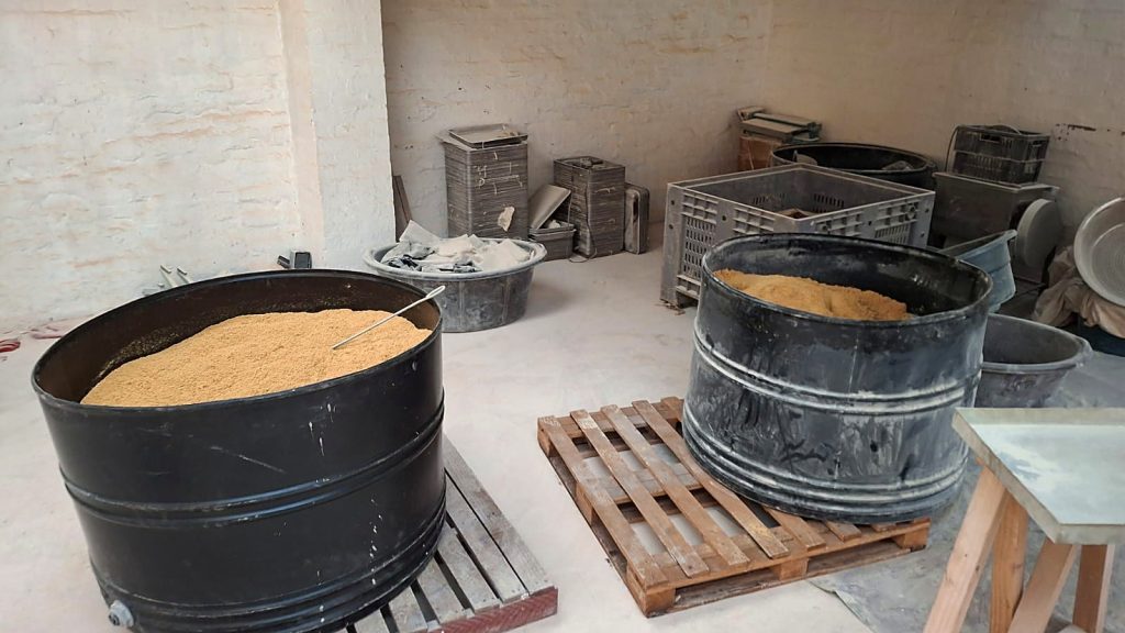 Open drums containing a yellow-brown granular substance at the Hekpoort property. Police have not publicly confirmed forensic results for the substances found.