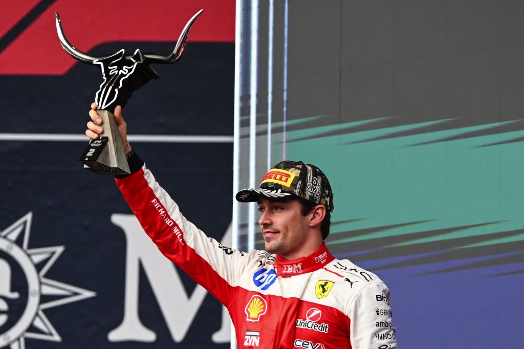 Charles Leclerc lifts his trophy after finishing second for Ferrari, 13.078 seconds behind Antonelli.